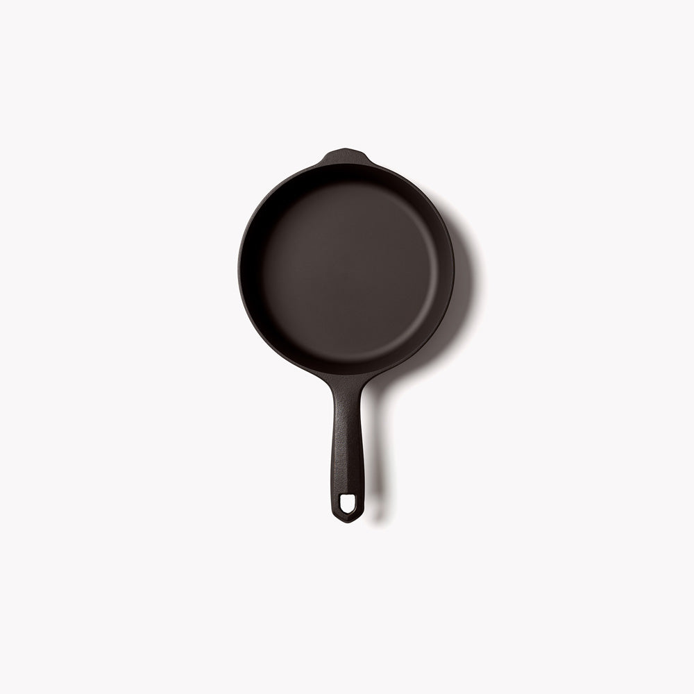 Small Field cast iron skillet from above, empty, handle pointing down