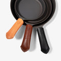 Cognac, brown and black Field leather handle covers on three cast iron skillet handles thumbnail