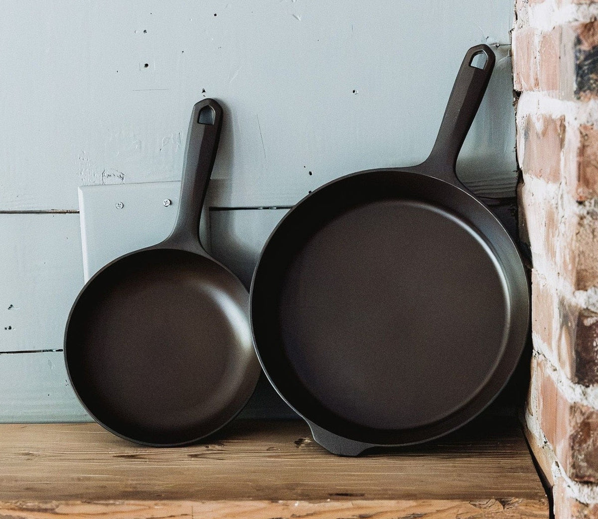 Field Company No.5 and No.8 cast iron skillets on a wood shelf