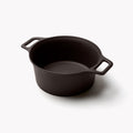 Field cast iron Dutch oven without its lid, angled to show the interior and loop handles thumbnail