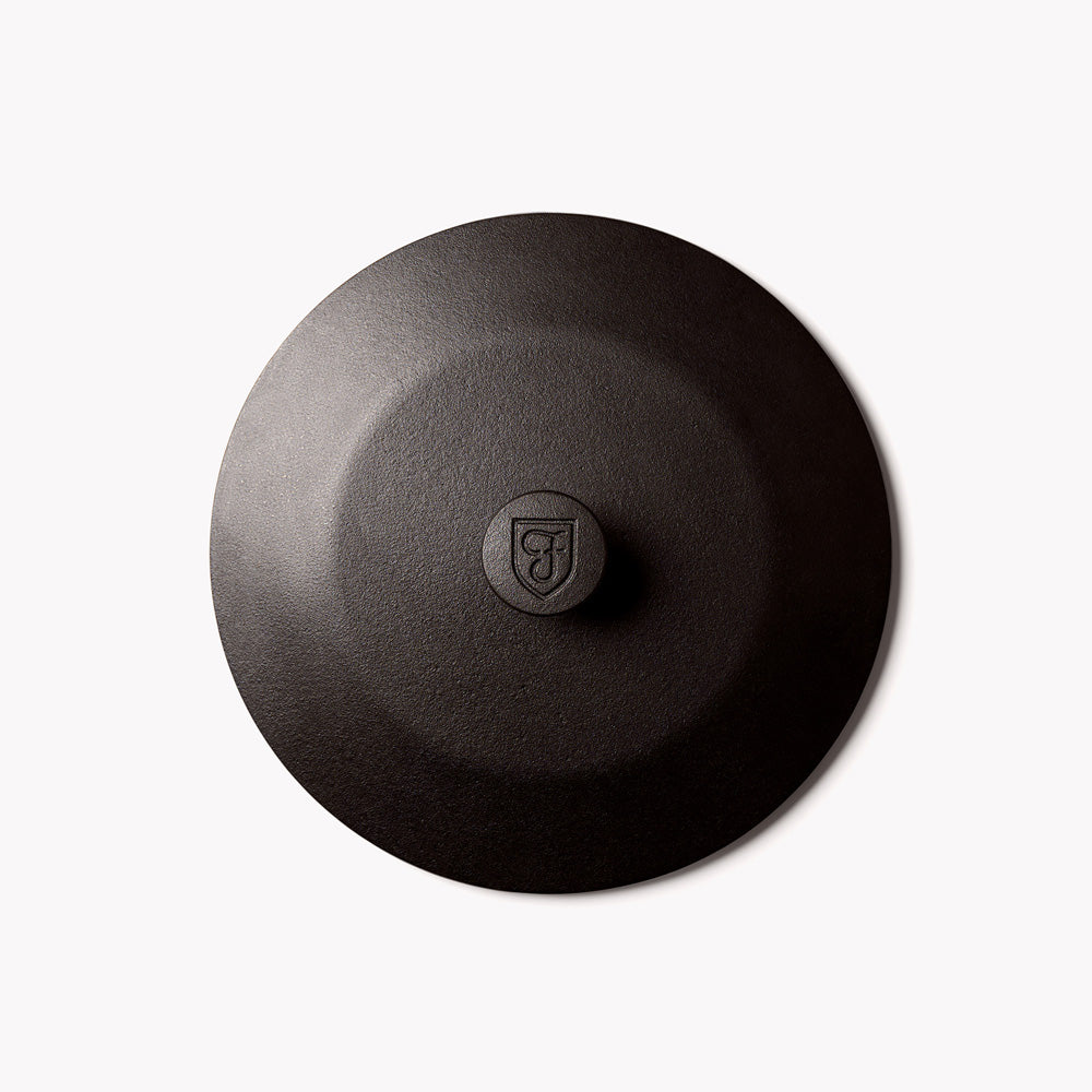 Field Dutch oven lid seen from above, gently domed with a shield medallion knob
