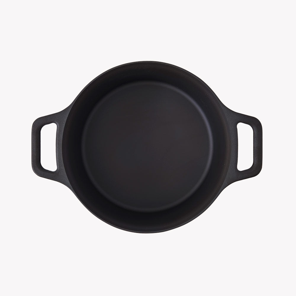 Field cast iron Dutch oven from above, empty, with a loop handle at each side